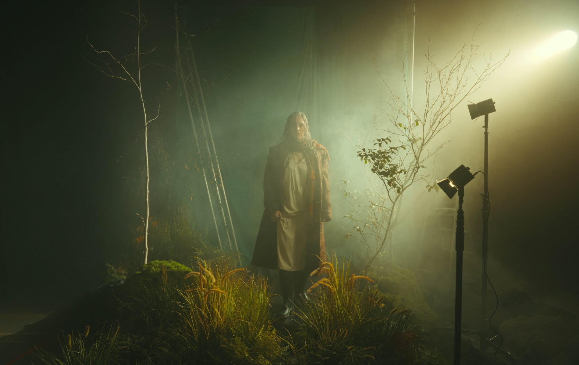 Desiree Frahn stands in mist, with stage lights shining on her